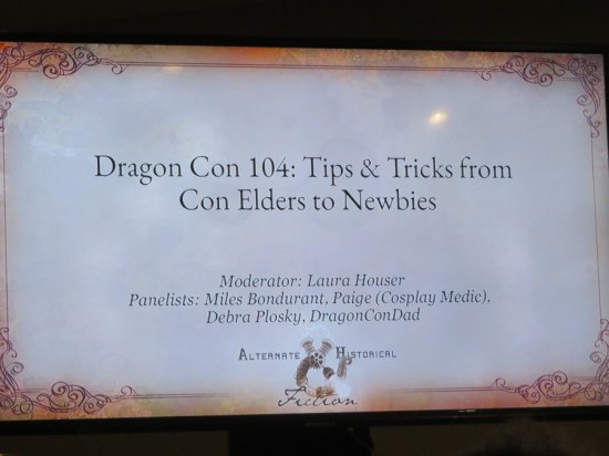 A PowerPoint slide with the name of the panel and its participants' preferred names: Laura Houser, Miles Bondurant, Paige (Cosplay Medic), Debra Plosky and DragonConDad.