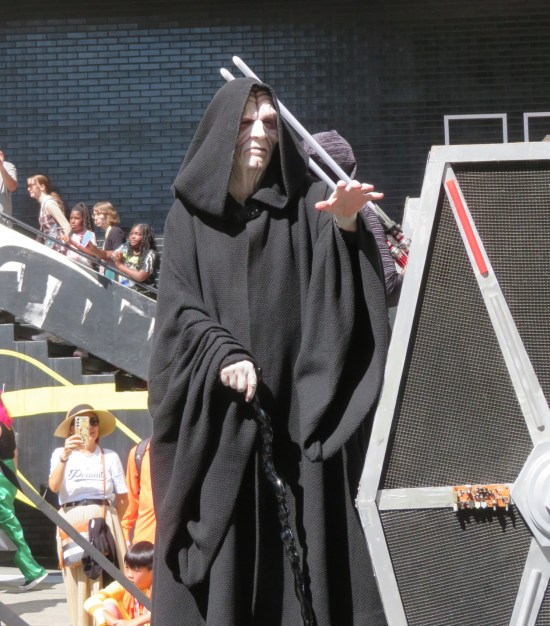 Emperor Palpatine raising his hand to zap someone with Force-lightning.