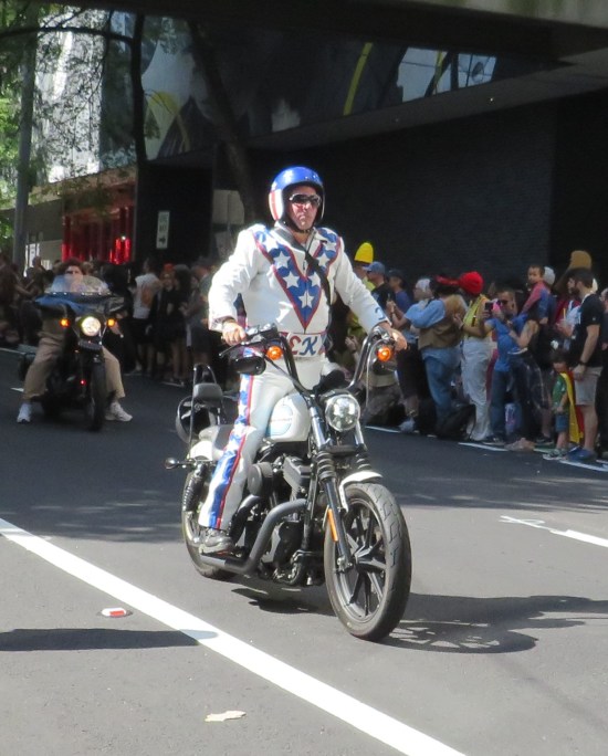 Evil Knievel cosplayer on a motorcycle.