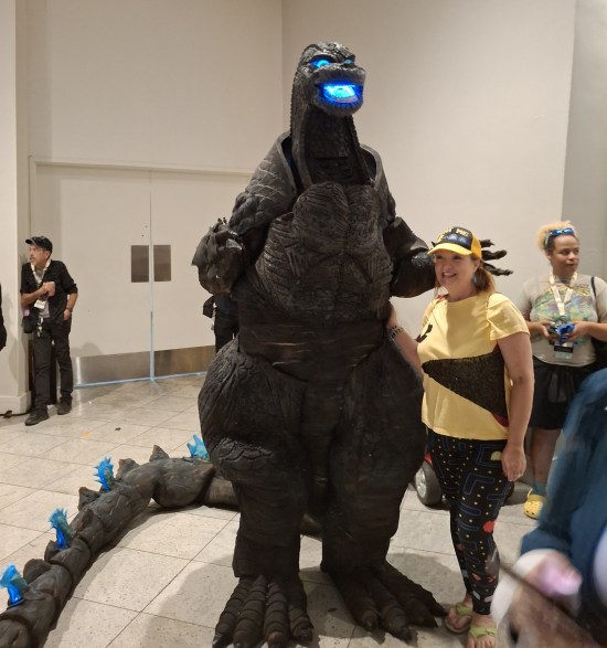 Nine-foot-tall Godzilla costume with eyes and mouth glowing blue.