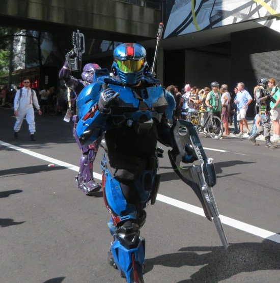 HALO blue armor with red highlights, doing a devil-horn gesture at the camera.