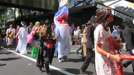Numerous cosplayers parading, most bleeding.