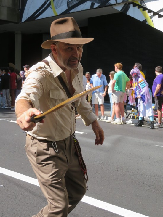 Indiana Jones cosplayer brandishing a machete at us.