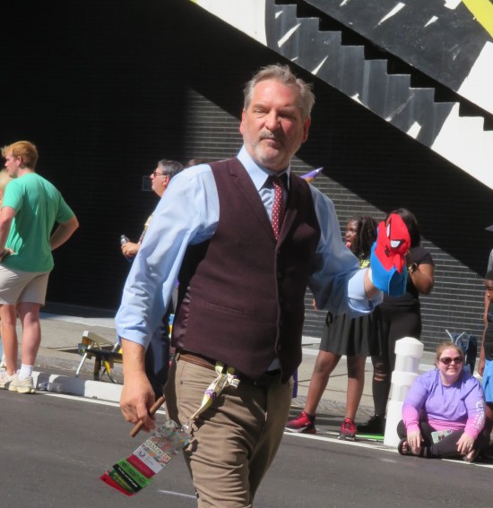 J. Jonah Jameson cosplayer with Spider-Man puppet on one hand.