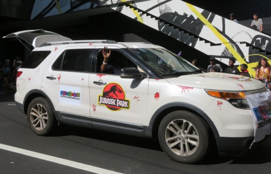 White SUV with Jurassic Park door decal and fake dinosaur claw scratches all over.