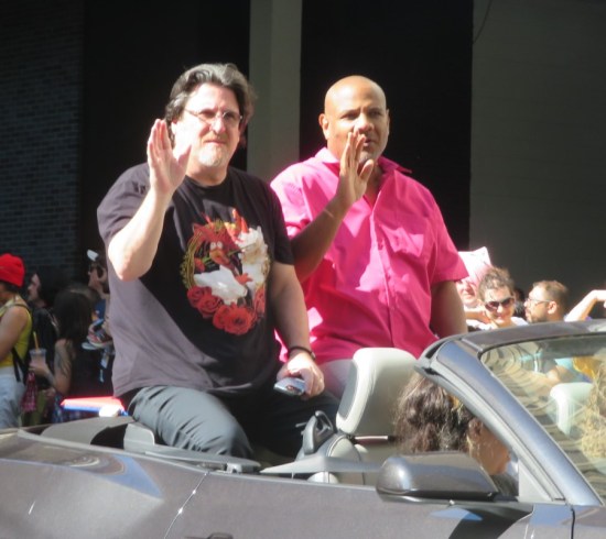 Kevin Clash and Bill Barrett riding in the back of a convertible and exhausted.