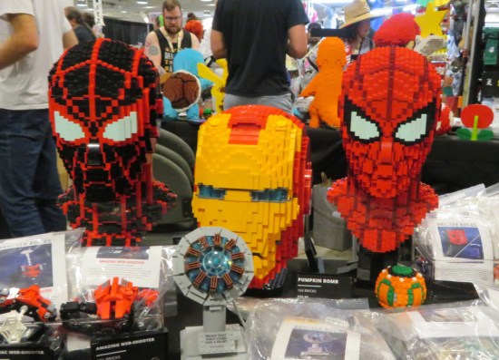 Lego life-size heads of Miles Morales, Iron Man and Spider-Man.