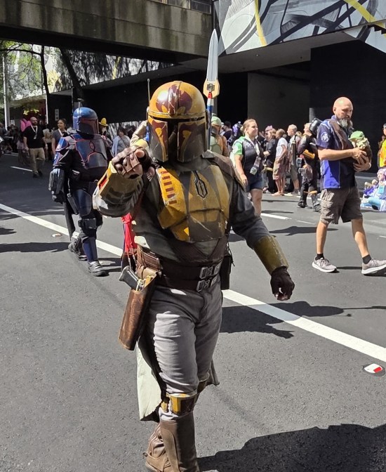 Mostly yellow Mandalorian pointing at you.