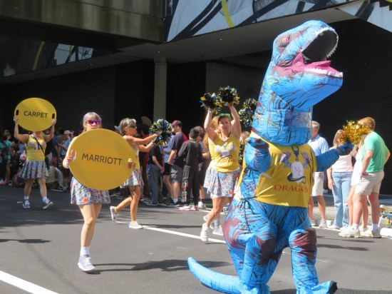 One inflatable blue dinosaur costume and cheerleaders dressed in the same unpleasingly distinctive carpet pattern.