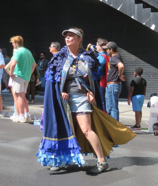 Woman in blue cape with Marriott Marquis carpet trim and Marriott Marquis visor.