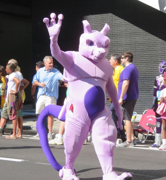 Mewtwo purple costume, waving hi.