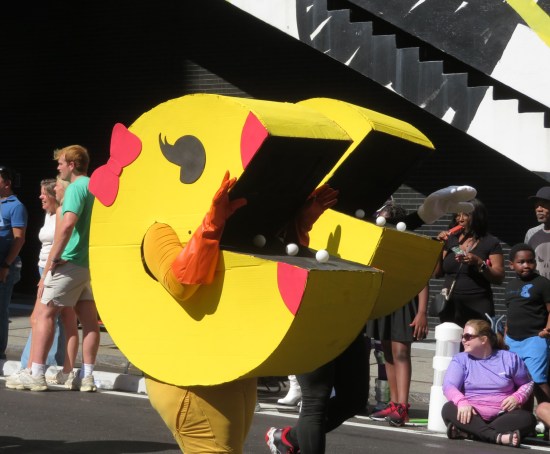 Ms. Pac-Man cosplayer standing in front of a Pac-Man cosplayer.