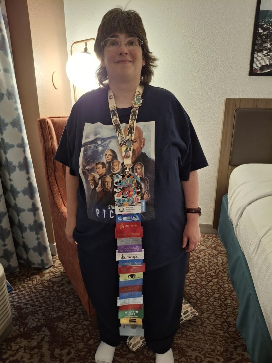 Anne wearing eighteen ribbons on her badge, nearly reaching the floor because she's five feet tall.