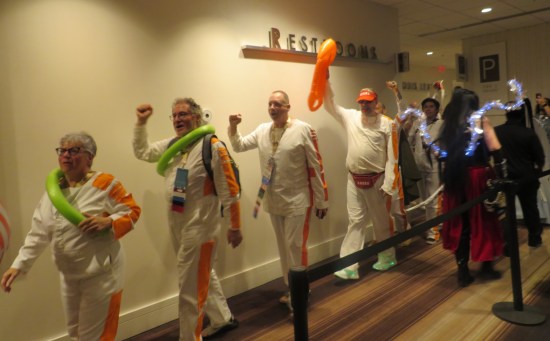 Line of Star Wars fans in Narkina 5 orange-and-white convict jumpsuits.