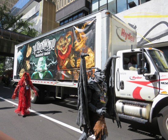 Semi covered on one side by Netherworld banner. Two horror cosplayers walk alongside.