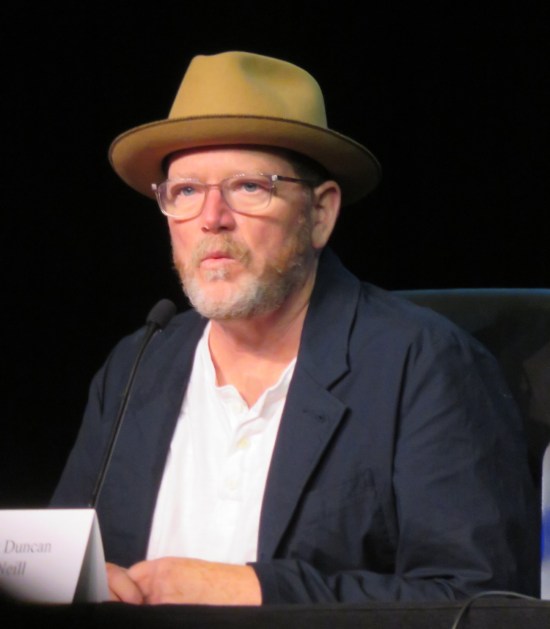 Robert Duncan McNeill in glasses and yellowish fedora.