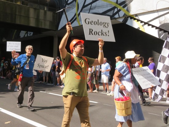 Skeptics members with signs reading "YAY SPACE!", "GEOLOGY ROCKS", and "We're made of star-stuff."