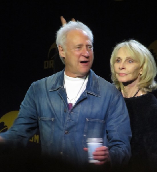 Spiner and McFadden onstage. She gives him rabbit ears.