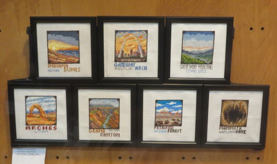 Seven needlework portraits of six major parks and the St. Louis Gateway Arch.