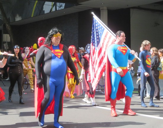 Superman and Eradicator costumes leading a pack of heroes.