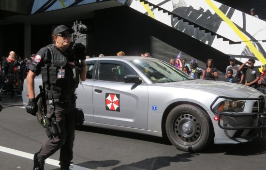 Silver car with Umbrella Corporation decals.