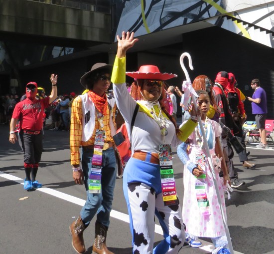 Woody Jessie and Bo Peep costumes. Behind them is an army of Deadpool variants.