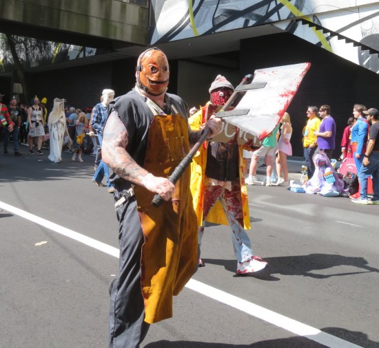 Costume: big bald killer with flesh face, apron and bloody surgical ax.