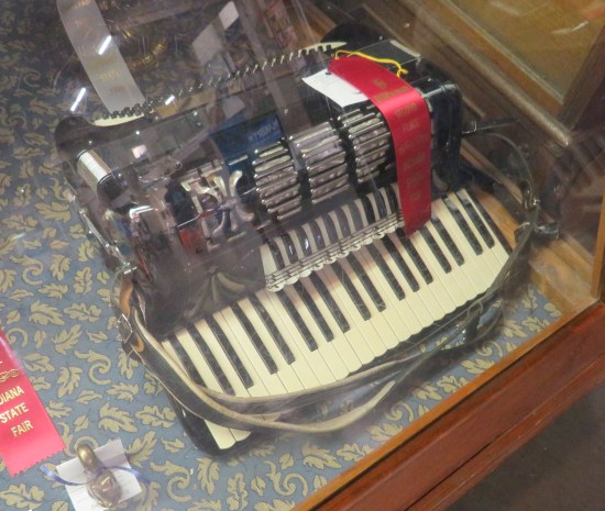 accordion lying in a display case.