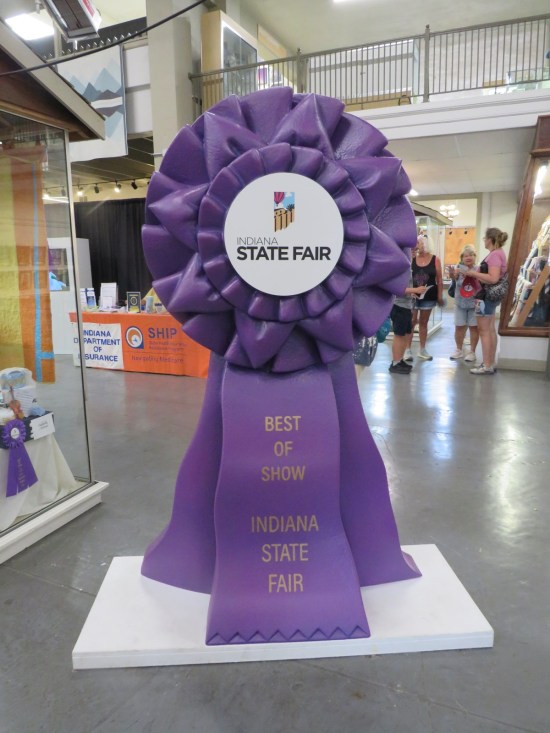 Six-foot-tall purple grand prize ribbon standing in the center of the Indiana Arts Building.