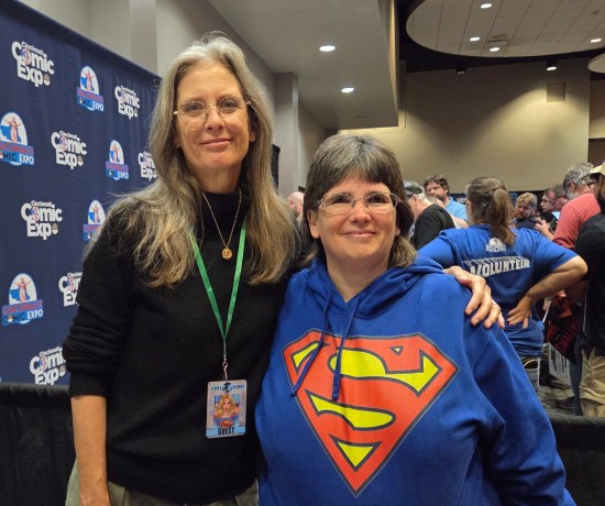 Anne in her big Superman hoodie posing with Helen Slater.