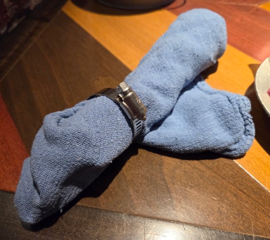 refer to caption, two sets on a wooden dining table.