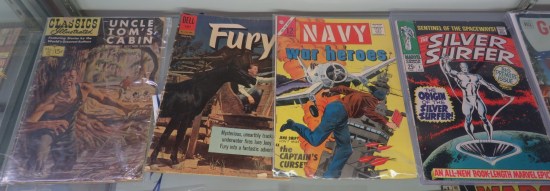 Four old comics in glass case per caption.
