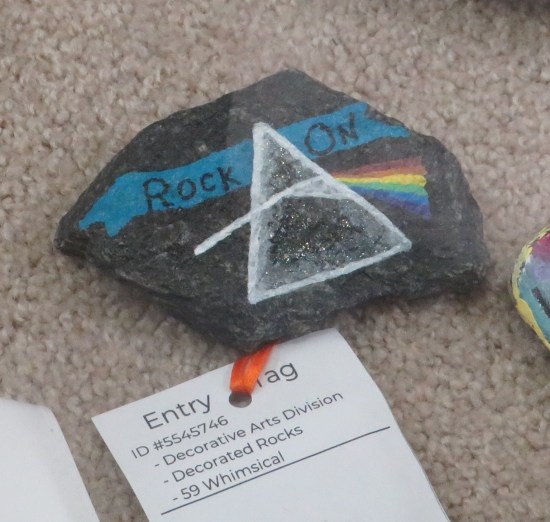 Hand-sized rock painted with the cover of Pink Floyd's "Dark Side of the Moon".