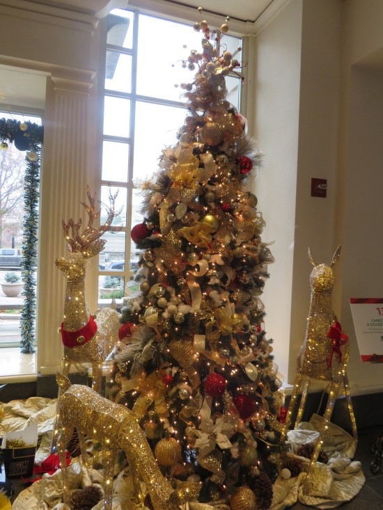 Christmas tree surrounded by three life-size reindeer wire sculptures whose necks moved back and forth.
