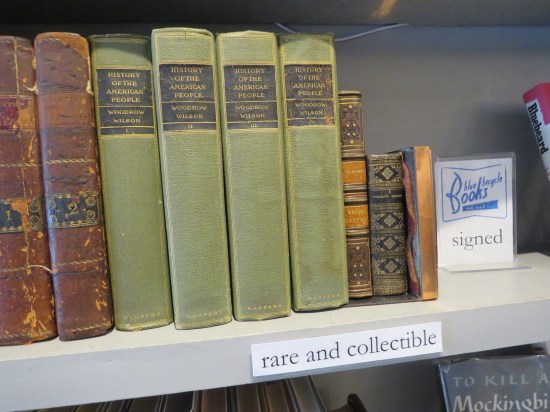 Store bookshelf labeled "Rare & Collectible". Books include four old green-covered volumes of Woodrow Wilson's "History of the American People".