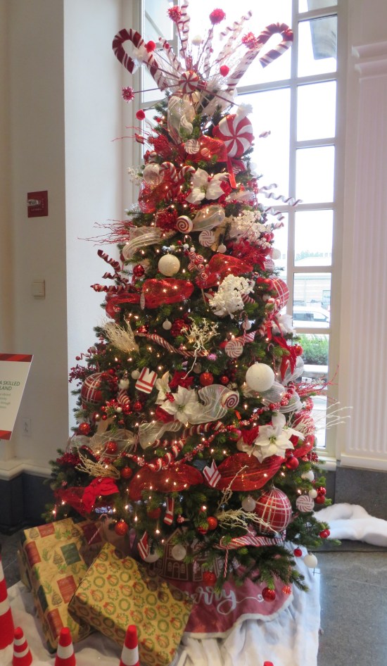 Christmas tree decorated all in red and white, most of them in a candy cane motif.