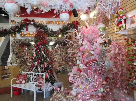 Store full of Christmas decorations, most prominently a full-size pink and white tree.