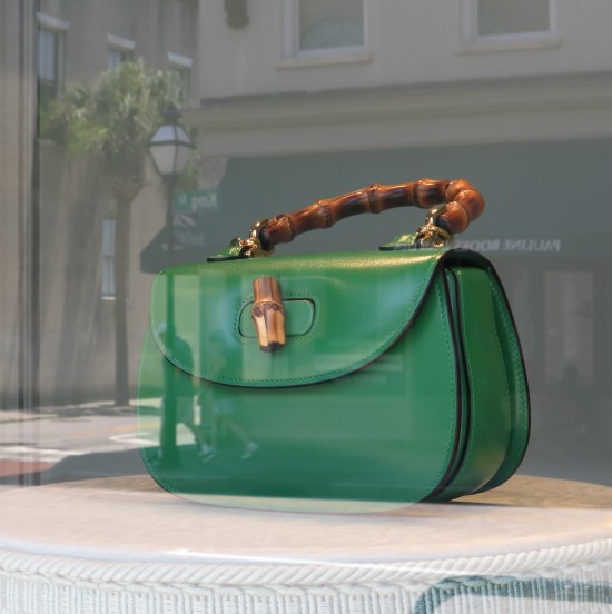 Green purse in a window display.
