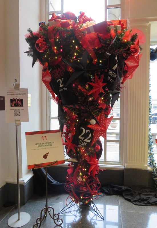 Upside-down Christmas tree with WNBA uniforms on it, most prominent being Caitlin Clark's.