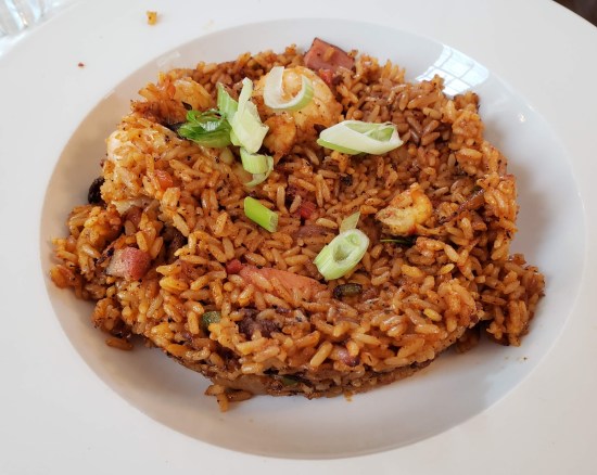 Jambalaya on white plate, refer to caption.