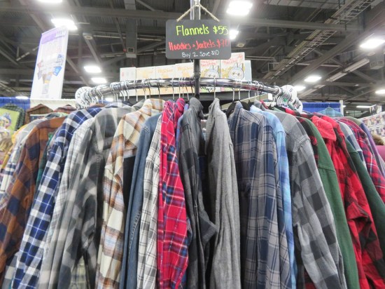 Circular rack of flannel shirts with a $55 price sign.