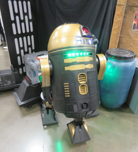black and gold astromech droid.