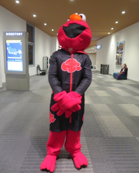 Elmo cosplayer in an Akatsuki robe from "Naruto".