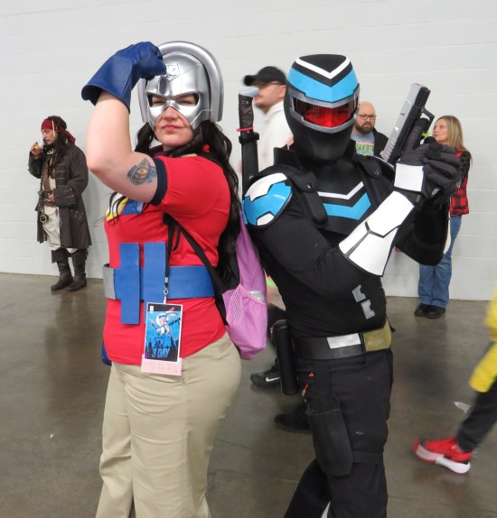 Peacemaker and Vigilante costumes back-to-back