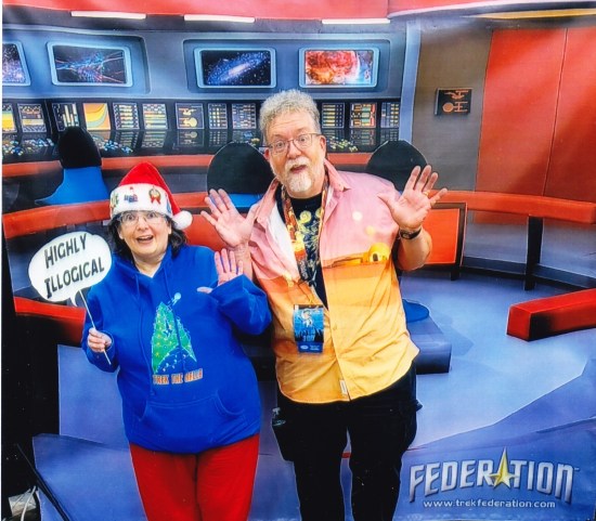 Us doing jazz hands in front of a backdrop of the Starship Enterprise's bridge. Anne has a stick-balloon reading "Highly illogical!"