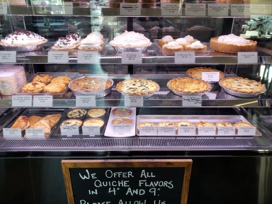 Glass bakery case with quiches and pies in a plethora of flavors.