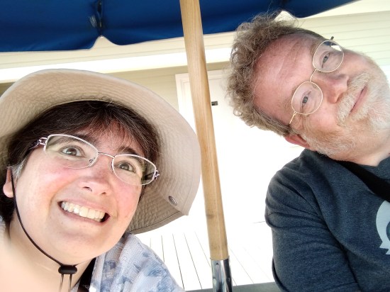 Anne and me smiling into camera while sitting in deck chairs.