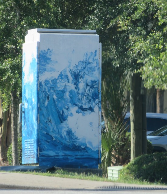 lightbox with seawater painted on it, on a city street.