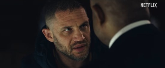 Corrupt cop Tom Hardy stares down Forest Whitaker.