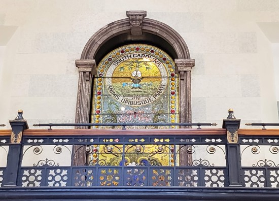 Stained-glass South Carolina state seal, door-shaped and arched. Inscription "Animis Opibusque Prati".